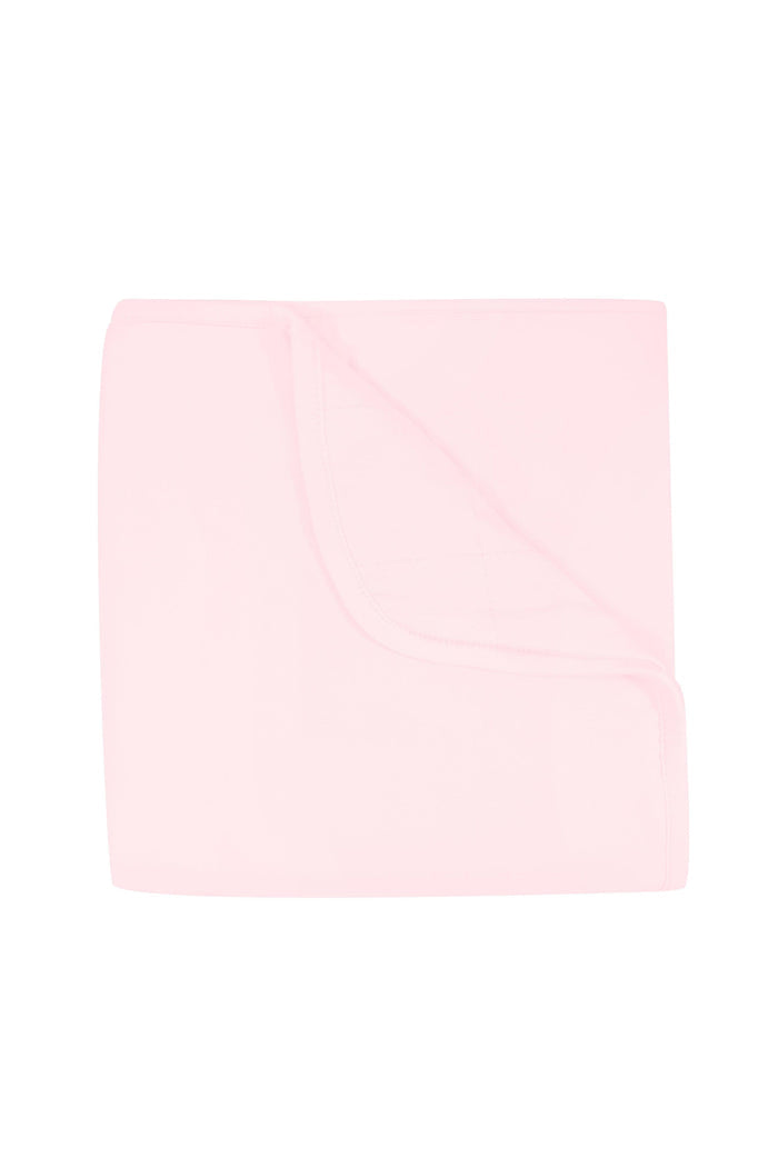 Solid light pink color blanket on a white background