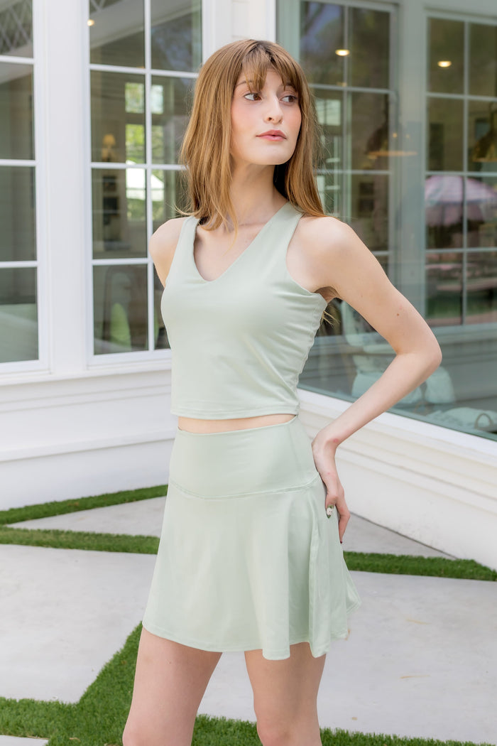 Female modeling the Bamboo Flex Bra Tank in Basil with matching Basil skort