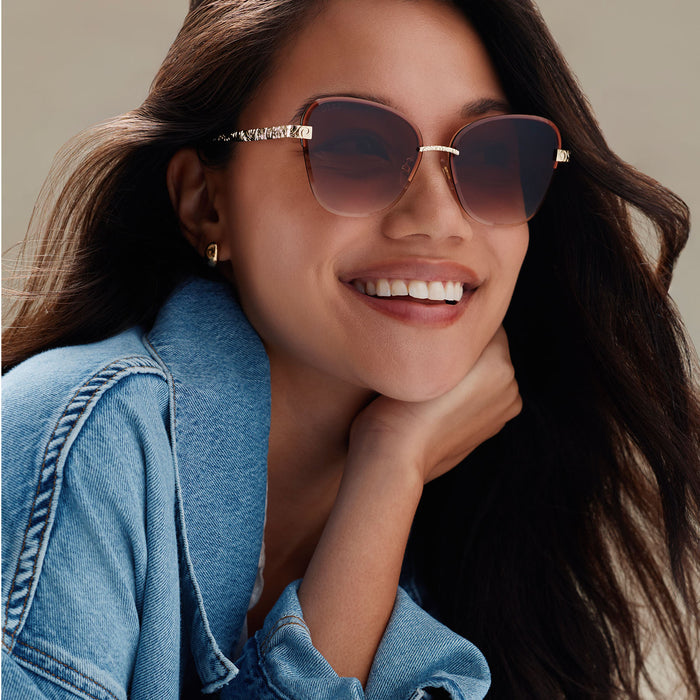 lifestyle - female wearing diff eyewear x disney princess featuring the belle 3.0 cateye sunglasses with a metal gold frame and brown gradient lenses angled view