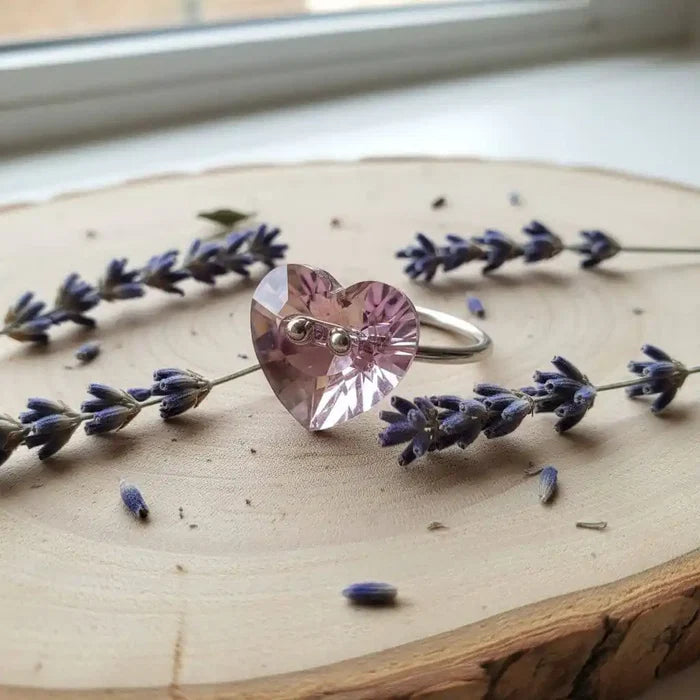 Big Girl Large Light Purple I LOVE YOU Heart Bling Ring surrounded by lavender on a wooden surface.