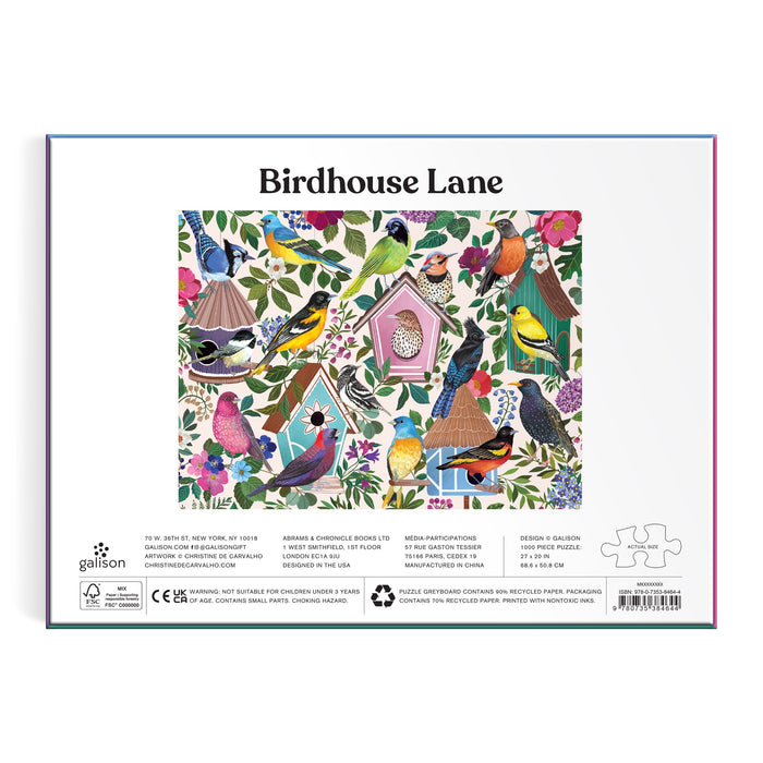 The back of the Birdhouse Lane 1000 Piece Puzzle by Christine De Carvalho shows a vibrant scene of birds and birdhouses amid flowers and leaves. The title is at the top, with brand and product details underneath.
