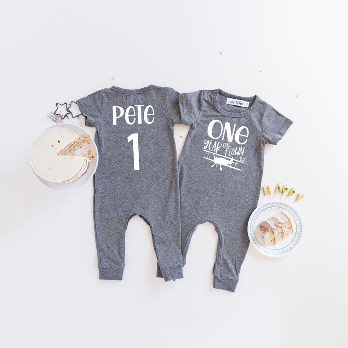 Black "One Year Has Flown By" Airplane Slim Fit 1st Birthday Romper