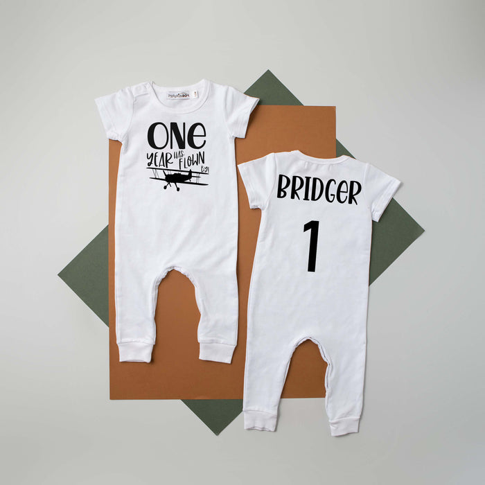 Black "One Year Has Flown By" Airplane Slim Fit 1st Birthday Romper