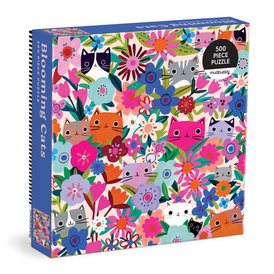 The Tara Lilly Blooming Cats 500 Piece Puzzle features a vibrant illustration of colorful cats among playful flowers and leaves for a fun, eye-catching challenge.