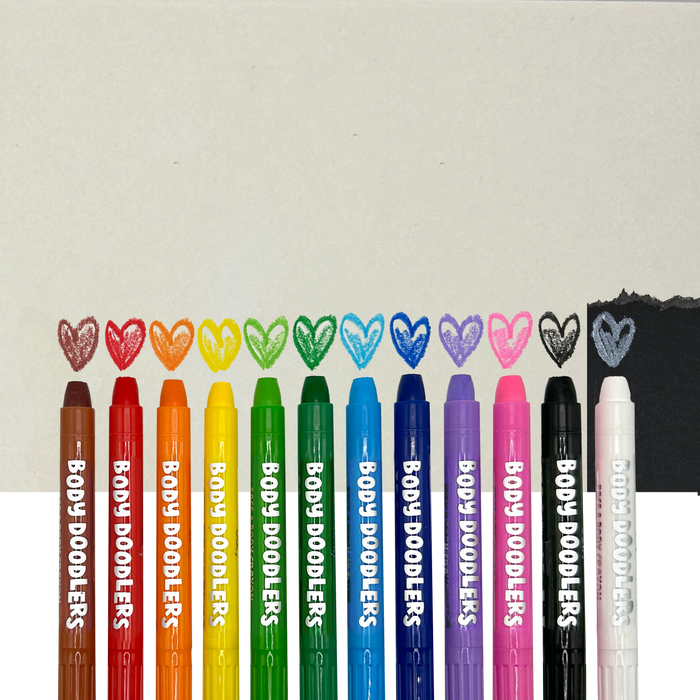 Row of OOLY Body Doodlers - Face & Body Crayons against background and colored heart swatches