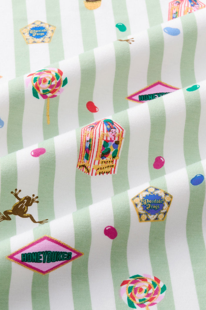 Close up of Green and white striped fabric with colorful Honeydukes Harry Potter pattern print
