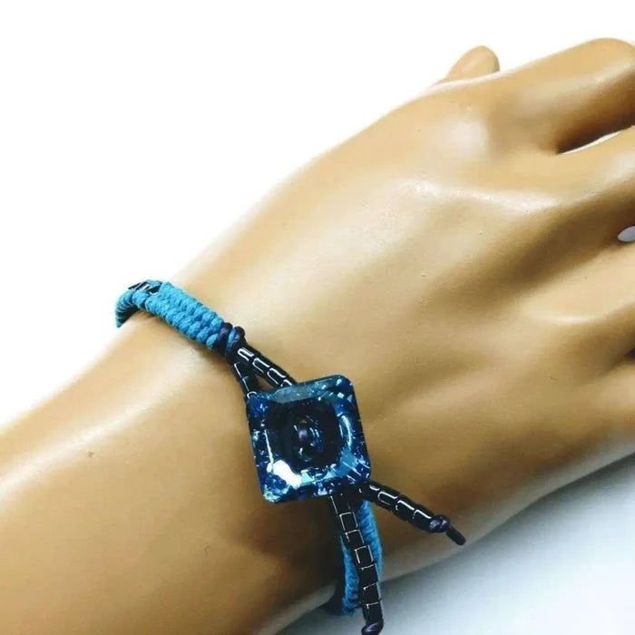 Aqua Hematite Bead Braided Swarovski Crystal Button Bracelet worn on a hand, featuring aqua beads and sparkling crystals.