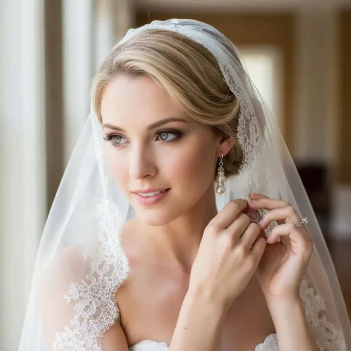 Bridal Sterling Silver Stacked Crystal and Pearl Earrings worn by a bride in a veil, radiating timeless elegance.