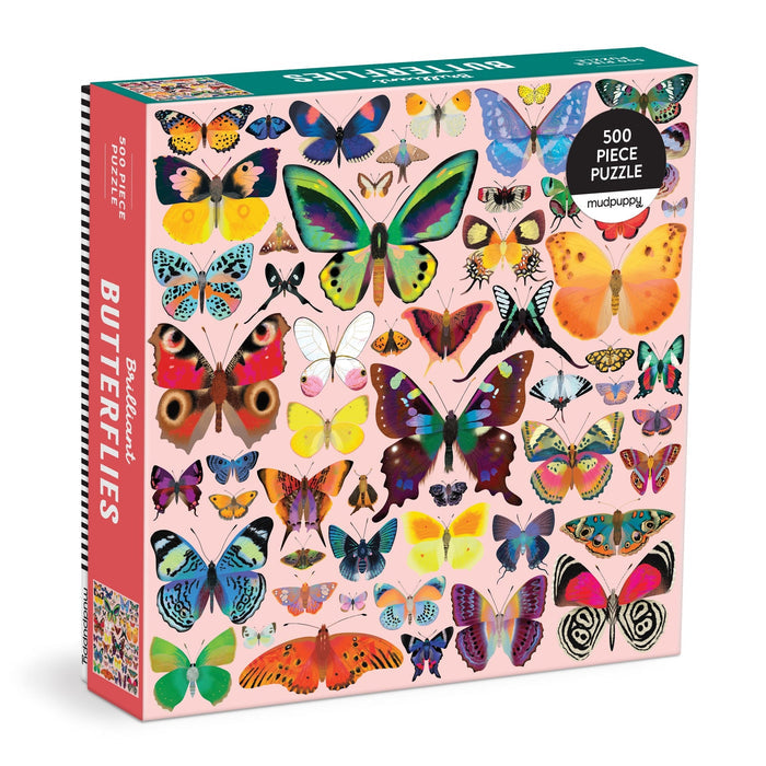 The Brilliant Butterflies 500 Piece Puzzle by Natasha Durley features colorful butterfly illustrations on a light pink background, with Butterflies on the side of the box and the artist’s name on the front.