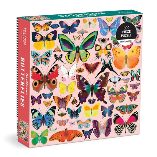 The Brilliant Butterflies 500 Piece Puzzle by Natasha Durley features colorful butterfly illustrations on a light pink background, with Butterflies on the side of the box and the artist’s name on the front.