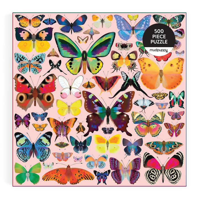 The Brilliant Butterflies 500 Piece Puzzle by Natasha Durley features vibrant butterfly illustrations in various shapes and sizes on a light pink background. The box displays the Mudpuppy logo in the top right corner.