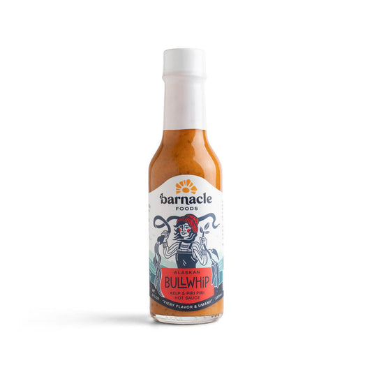 A bottle of 'Bullwhip' Kelp Hot Sauce with a label featuring a barnacle design and the name of the sauce prominently displayed.
