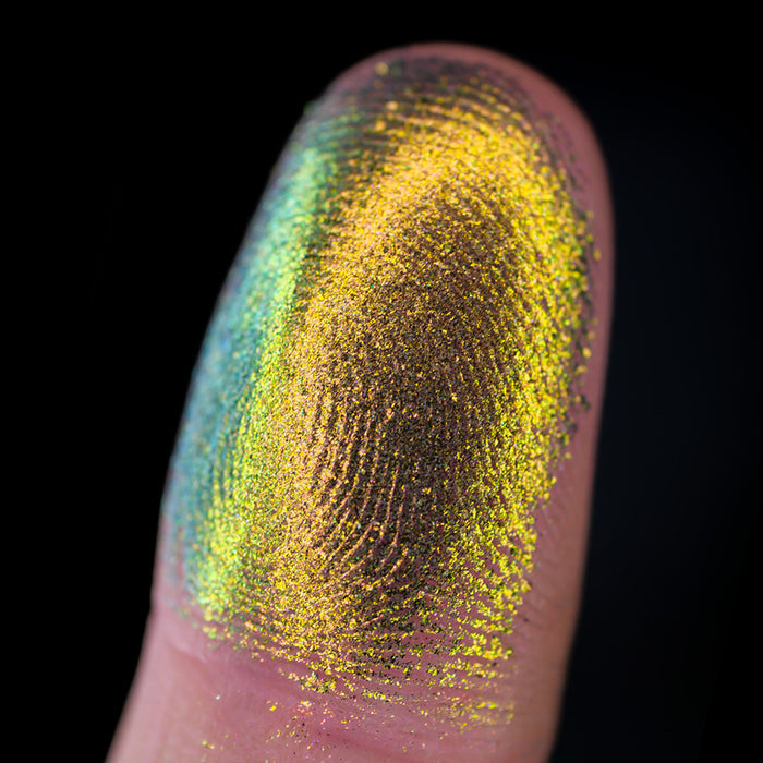 Macro finger swatch of Burnish Lite on fair skin tone.