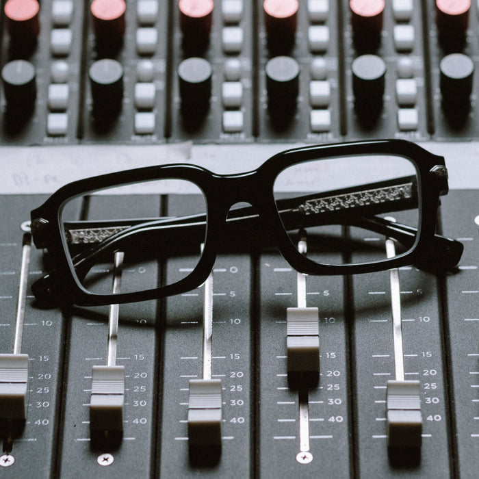lifestyle - diff eyewear x stephen wilson jr. calico creek square prescription glasses with a black acetate frame laying on music equipment