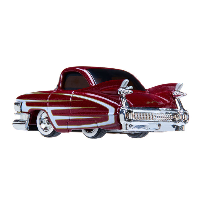 A classic red car with chrome details on a white background