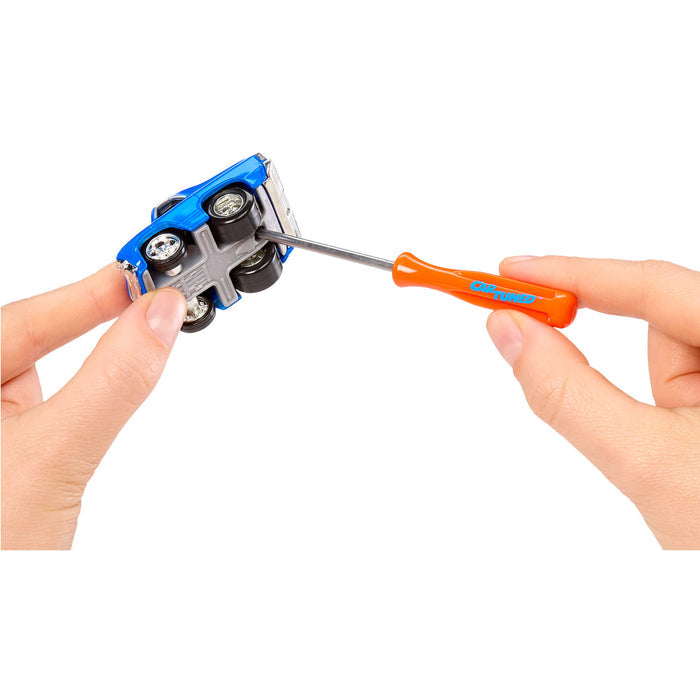Attaching top of car to bottom with a screwdriver being used on a white background