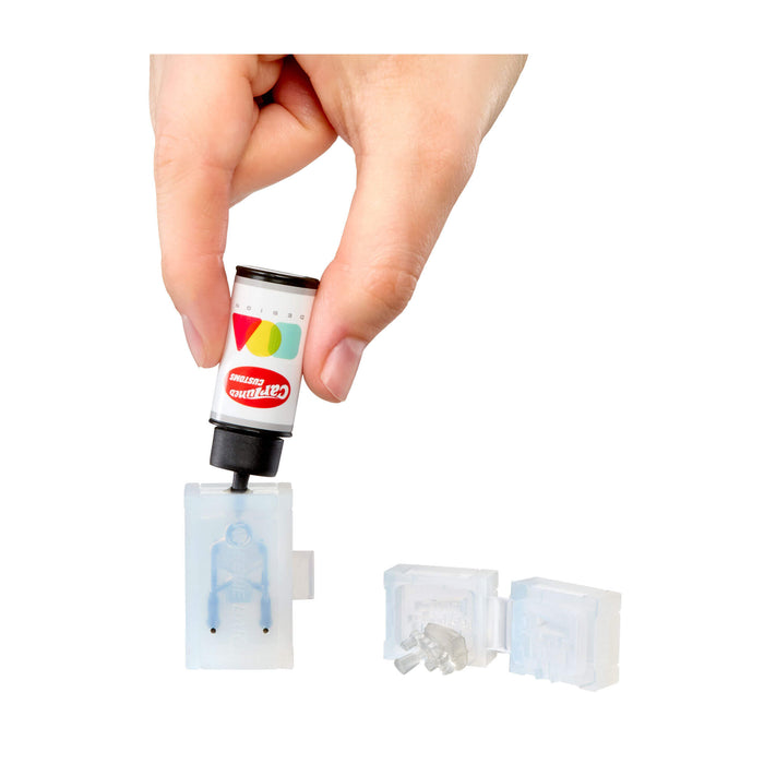 Hand holding a small cartridge with colorful design, white background