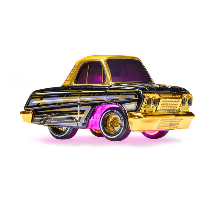 Toy car with gold and black design on a white background