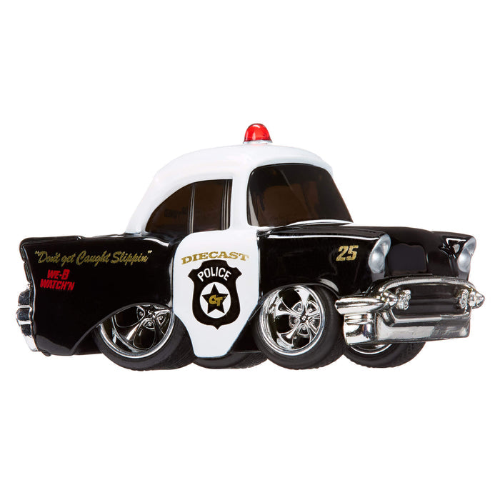 Vintage police car toy with a white roof and black body on a white background