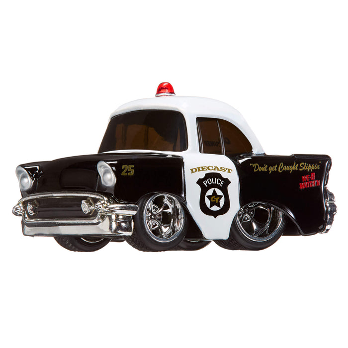 Toy police car with a red light on top, black and white color scheme, and visible branding.