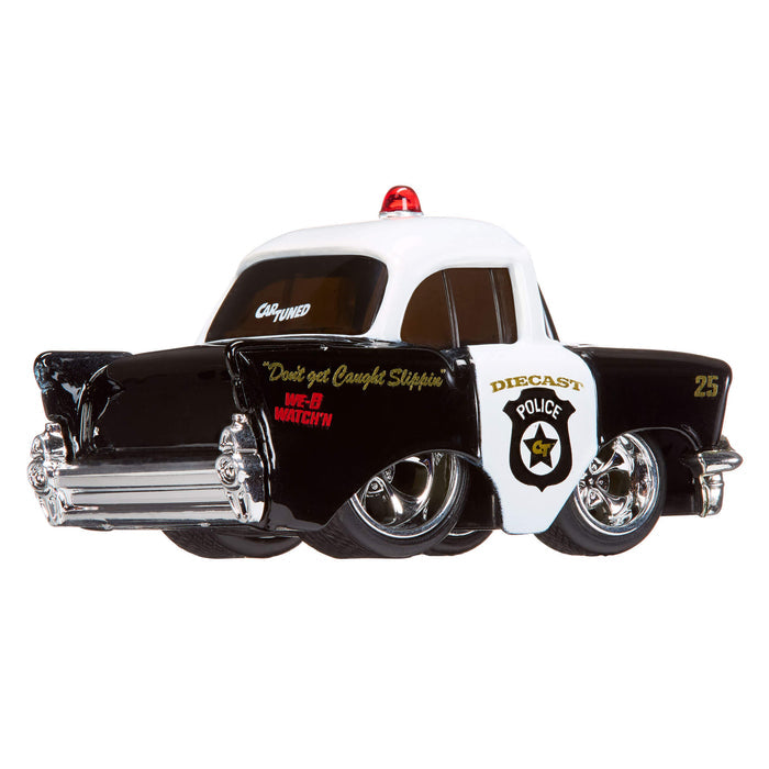 Model police car with a white top and black body on a white background