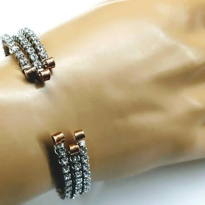 Catch-Free Crystal Rhinestone Tennis Bracelet Bangle worn on a wrist, showcasing its sparkling rhinestones and copper details.