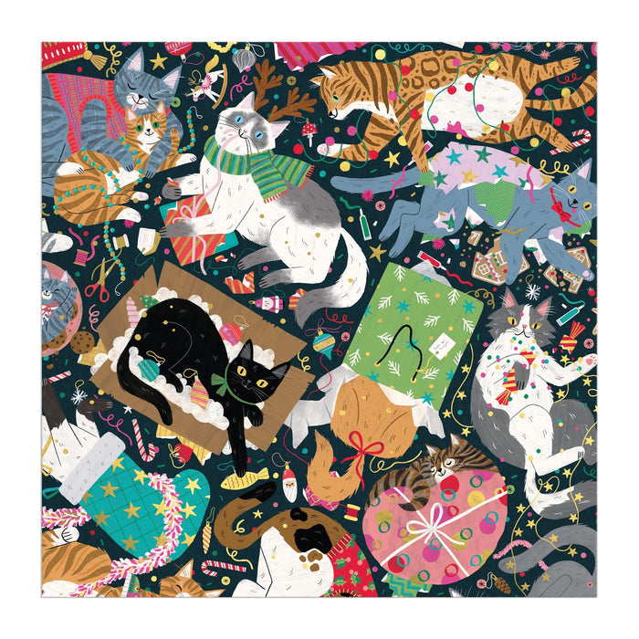 Maria Kee's Catmas Chaos 500 Piece Foil Puzzle features playful cats amid festive decorations, wrapping paper, gifts, and string lights on a dark background—perfect for holiday cat lovers and puzzle fans.