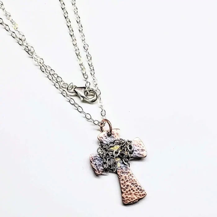 Chained Hammered Copper Cross Necklace For Him Or Her on a silver chain with intricate detailing.