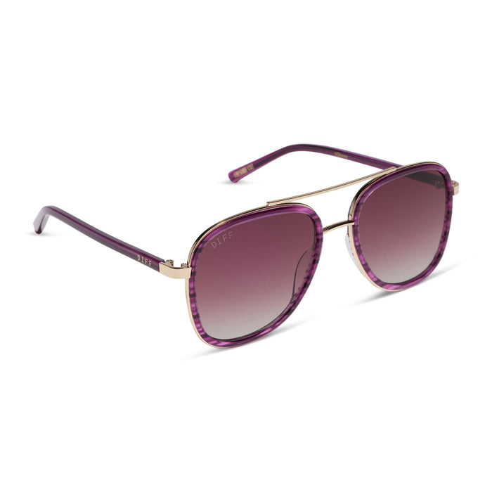 diff eyewear x disney alice in wonderland cheshire cate oversized navigator sunglasses with a purple frame and pink gradient lenses angled view