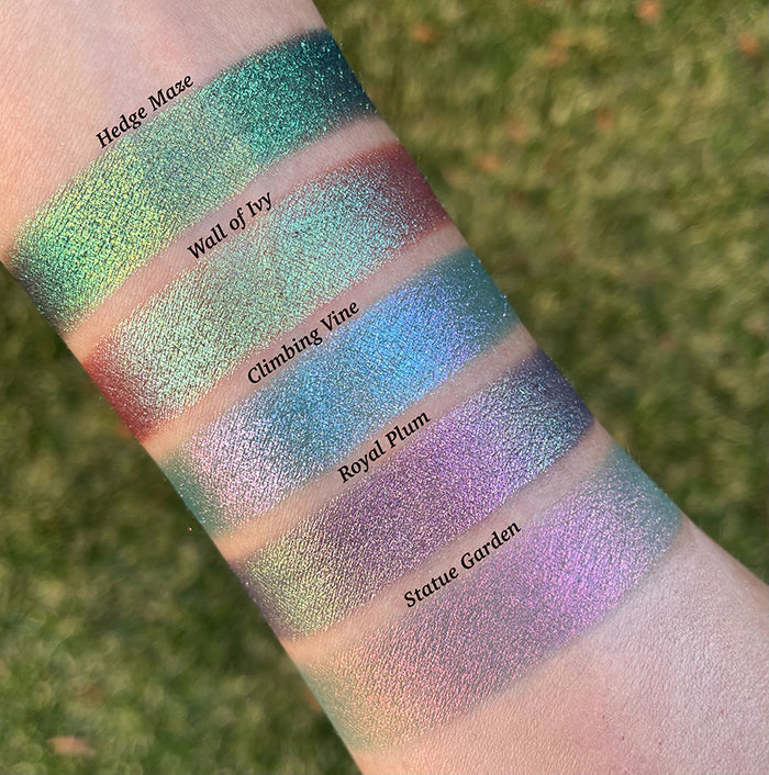 Top angled arm swatches on fair skin of Climbing Vine Earth Vibrant Multichrome Eyeshadow shifts compared to Hedge Maze, Wall of Ivy, Royal Plum and Statue Garden