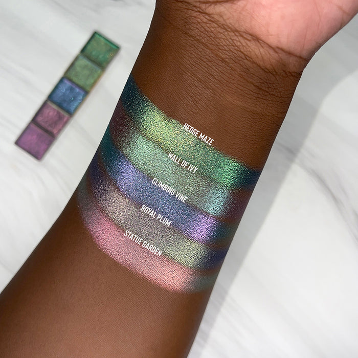 Top angled arm swatches on deep skin tone of Climbing Vine Earth Vibrant Multichrome shifts compared to Hedge Maze, Wall of Ivy, Royal Plum and Statue Garden
