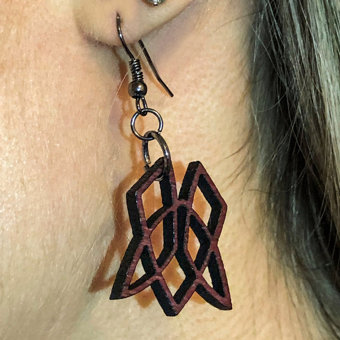 Purple Heart Clionadh symbol earrings being worn