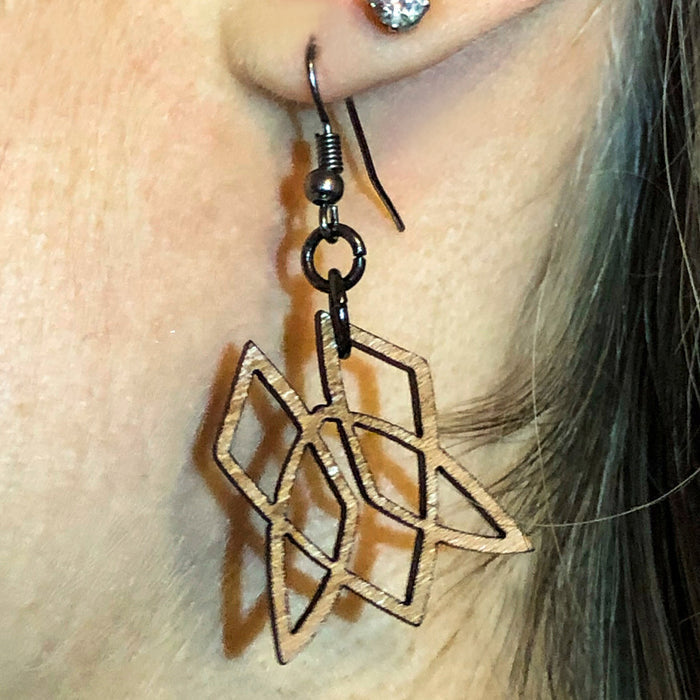 Cherry Clionadh symbol earrings being worn