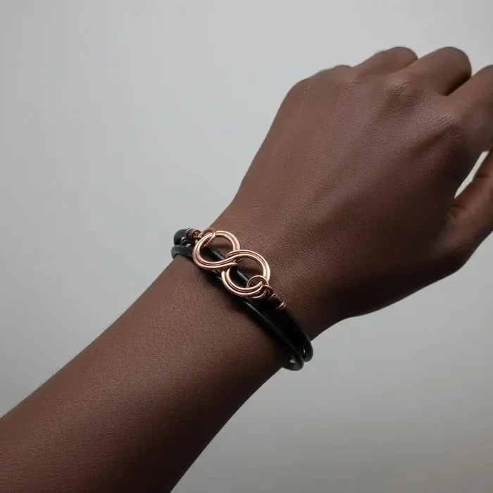 Copper Double Infinity Gender Neutral Leather Wrap Bracelet worn on a wrist showcasing its elegant design.