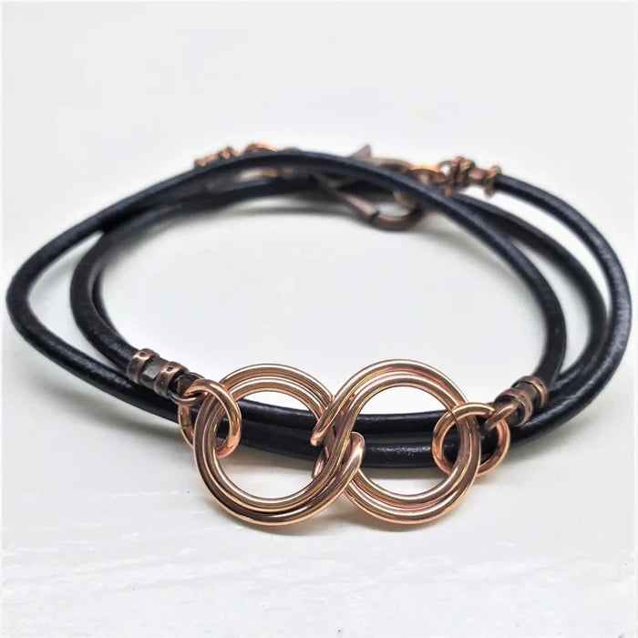 Copper Double Infinity Gender Neutral Leather Wrap Bracelet featuring intertwined copper infinity symbols on black leather.