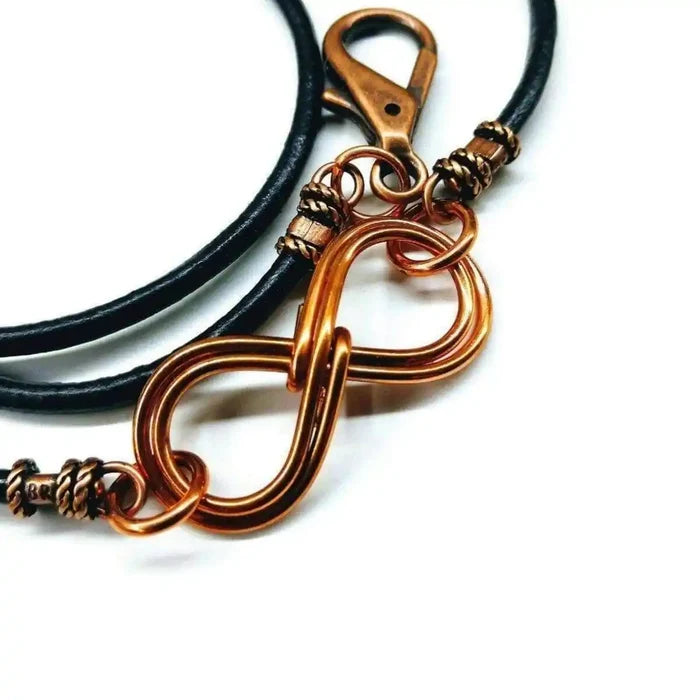 Copper Double Infinity Gender Neutral Leather Wrap Bracelet featuring intertwined copper infinity symbols on black leather.