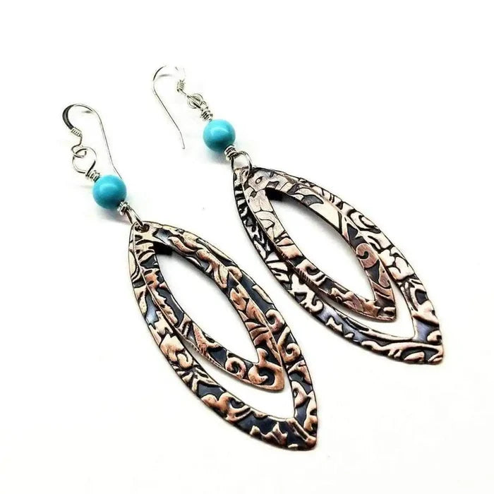 Copper Embossed Pointed Oval Turquoise Bead Earrings displayed with intricate designs and turquoise beads
