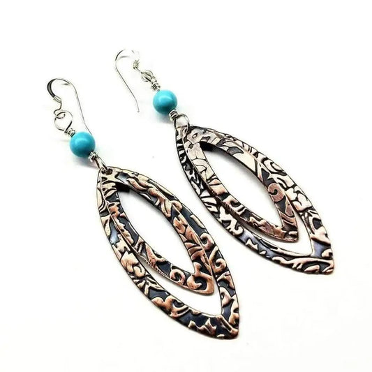 Copper Embossed Pointed Oval Turquoise Bead Earrings displayed with intricate designs and turquoise beads