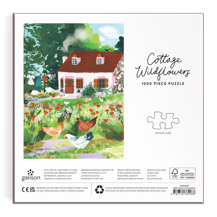 Joanna Clay’s Cottage Wildflowers 1000 Piece Puzzle in a Square Box features a red-roofed cottage, wildflowers, trees, birds, and chickens, plus a sample puzzle piece outline. Text on box: “Cottage Wildflowers 1000 Piece Puzzle.”.