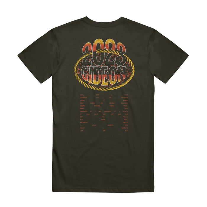 Back of shirt has "2023" written in bold letters fading from yellow, to red, to black on top center of shirt, with "GIDEON" printed right below in same font and colors. A yellow, horizontal oval is around the word "gideon" and passes through the number 0 in "2023".