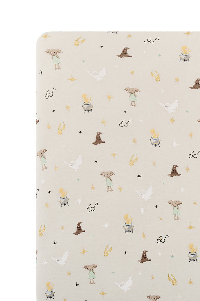 Beige crib sheet with Harry Potter print on a white background