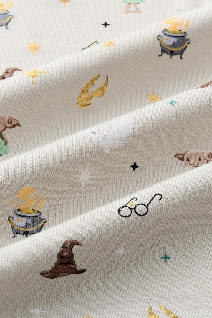 Close up of Beige fabric with Starry Icon Harry Potter patten print