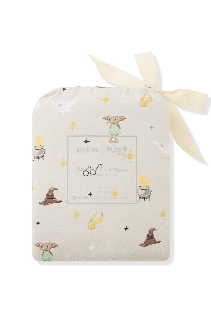 Beige Crib sheet packed in a bag with Harry Potter print on a white background