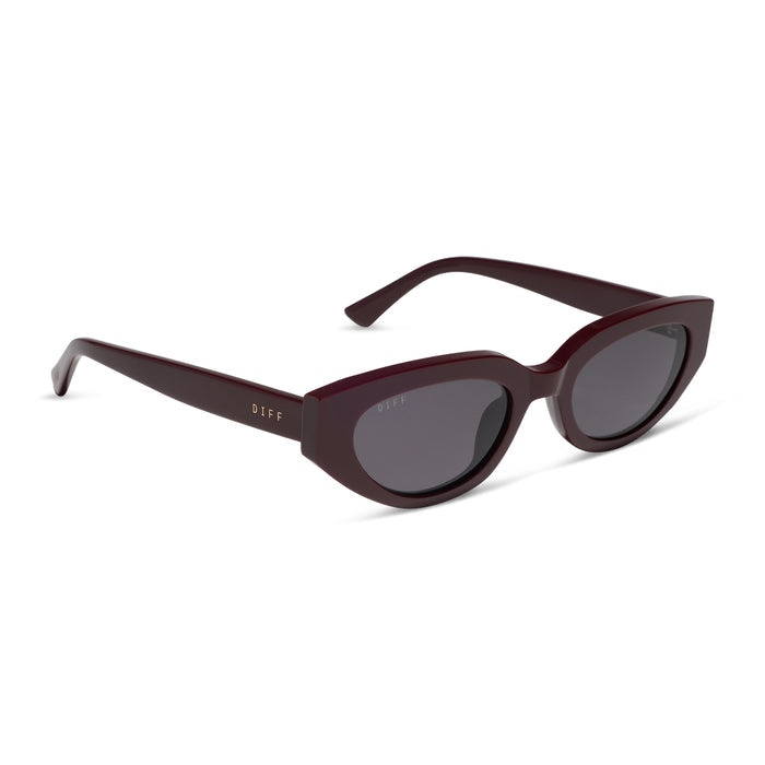 diff eyewear x jessie james decker crystal cat eye sunglasses with a burgundy red acetate frame and grey gradient polarized lenses angled view