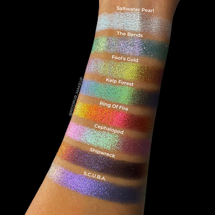 Arm swatches on medium skin tone of all eight eyeshadows included in the Deep Sea Treasures Palette.