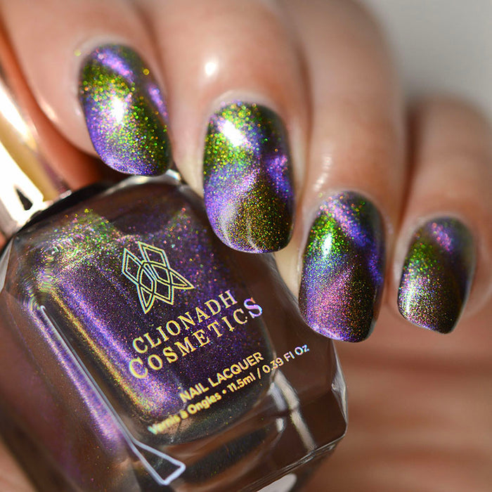 Close up shot of nails done with Distortion Nail Lacquer showing off the magnetic effect on medium skin tone