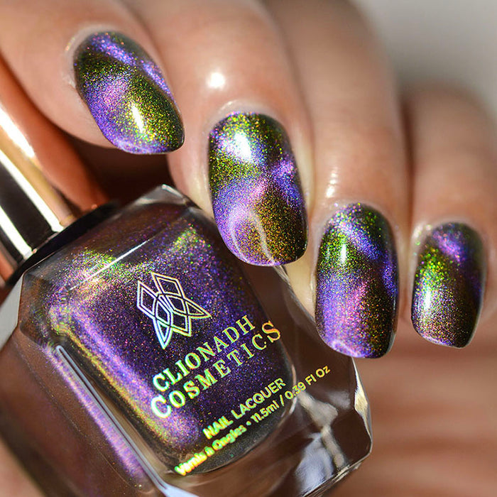 Close up shot of nails done with Distortion Nail Lacquer showing off the magnetic effect on medium skin tone