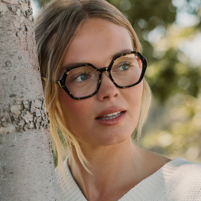 lifestyle - blonde female wearing diff eyewear featuring the dixie hexagon prescription glasses with a espresso tortoise frame and prescription lenses front view