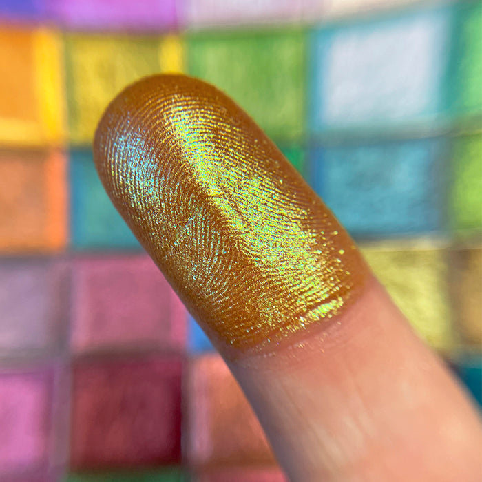 Close up finger swatch of Embellishment Glitter Multichrome Eyeshadow