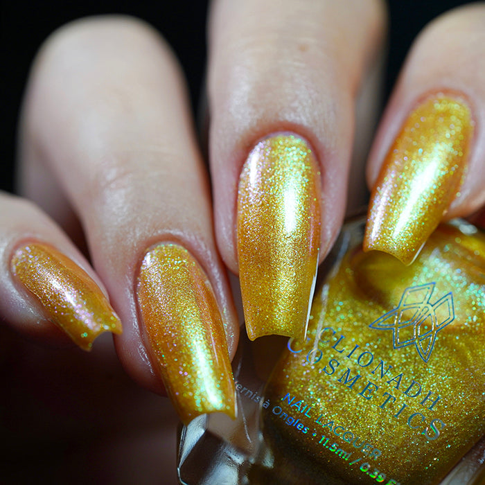 Close up shot of nails done with Embellishment nail lacquer on fair skin tone holding the nail lacquer bottle